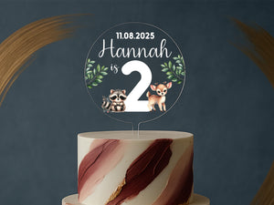 a cake with a cake topper that says hannah is 2