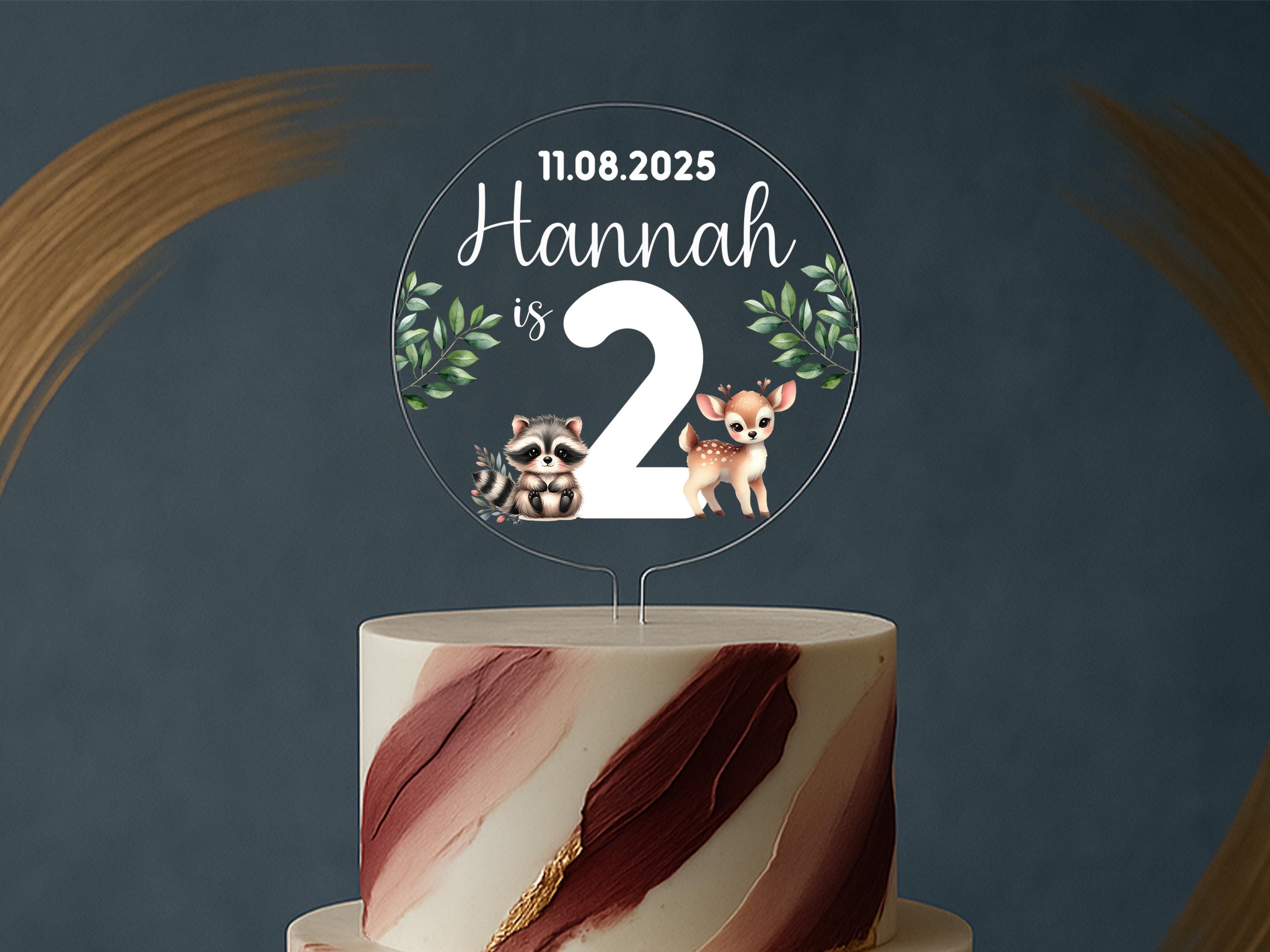 a cake with a cake topper that says hannah is 2