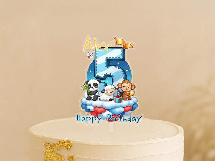 A birthday cake topper featuring a cartoon image of a panda, monkey, and sheep, along with the text "Happy Birthday Alex is 5".