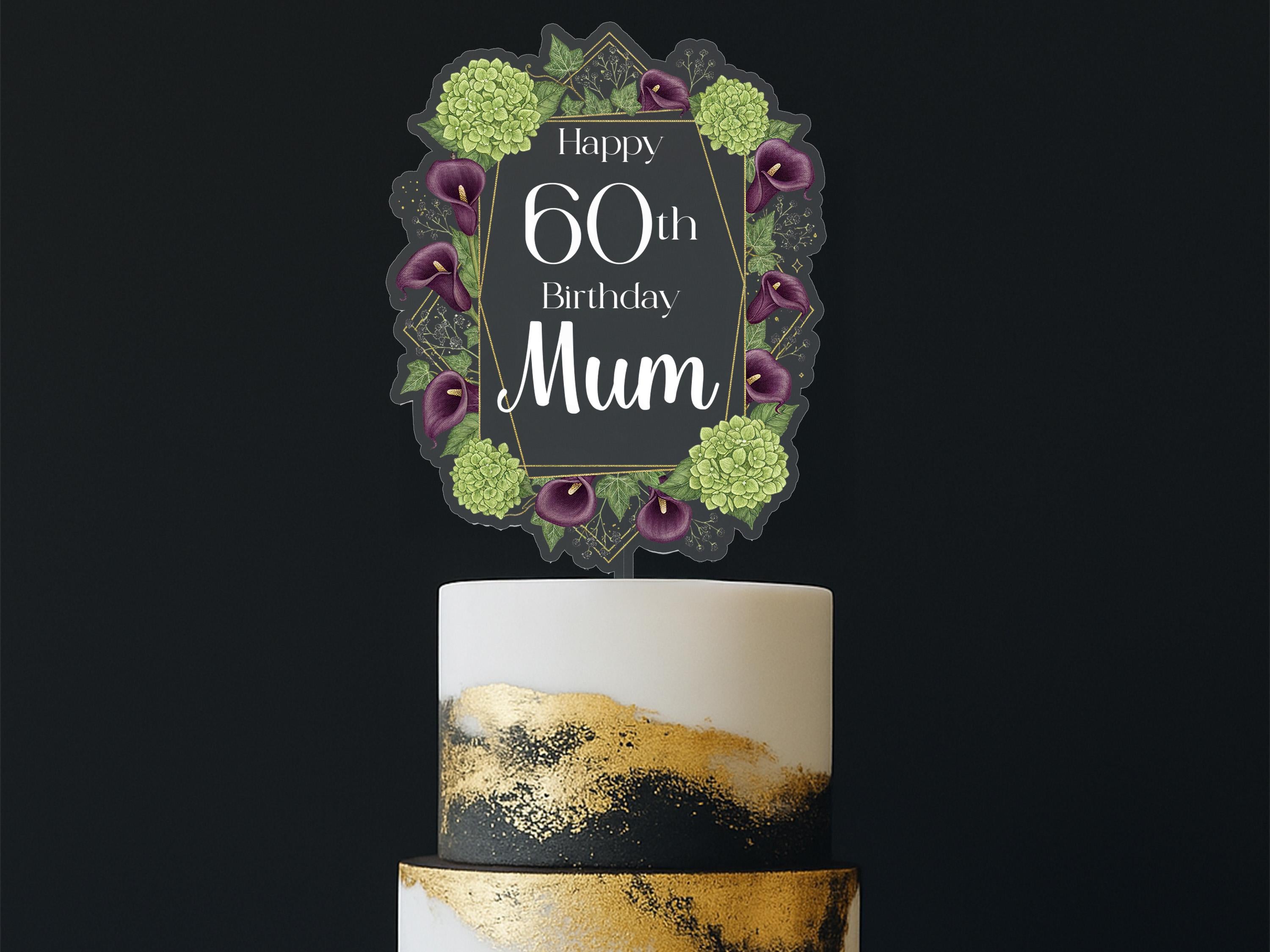 A birthday cake with a decorative topper that says "Happy 60th Birthday Mum" surrounded by a floral border.