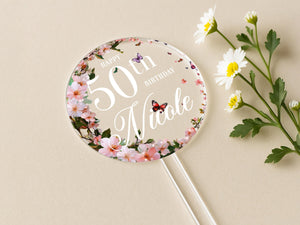 a birthday cake topper next to a flower bouquet