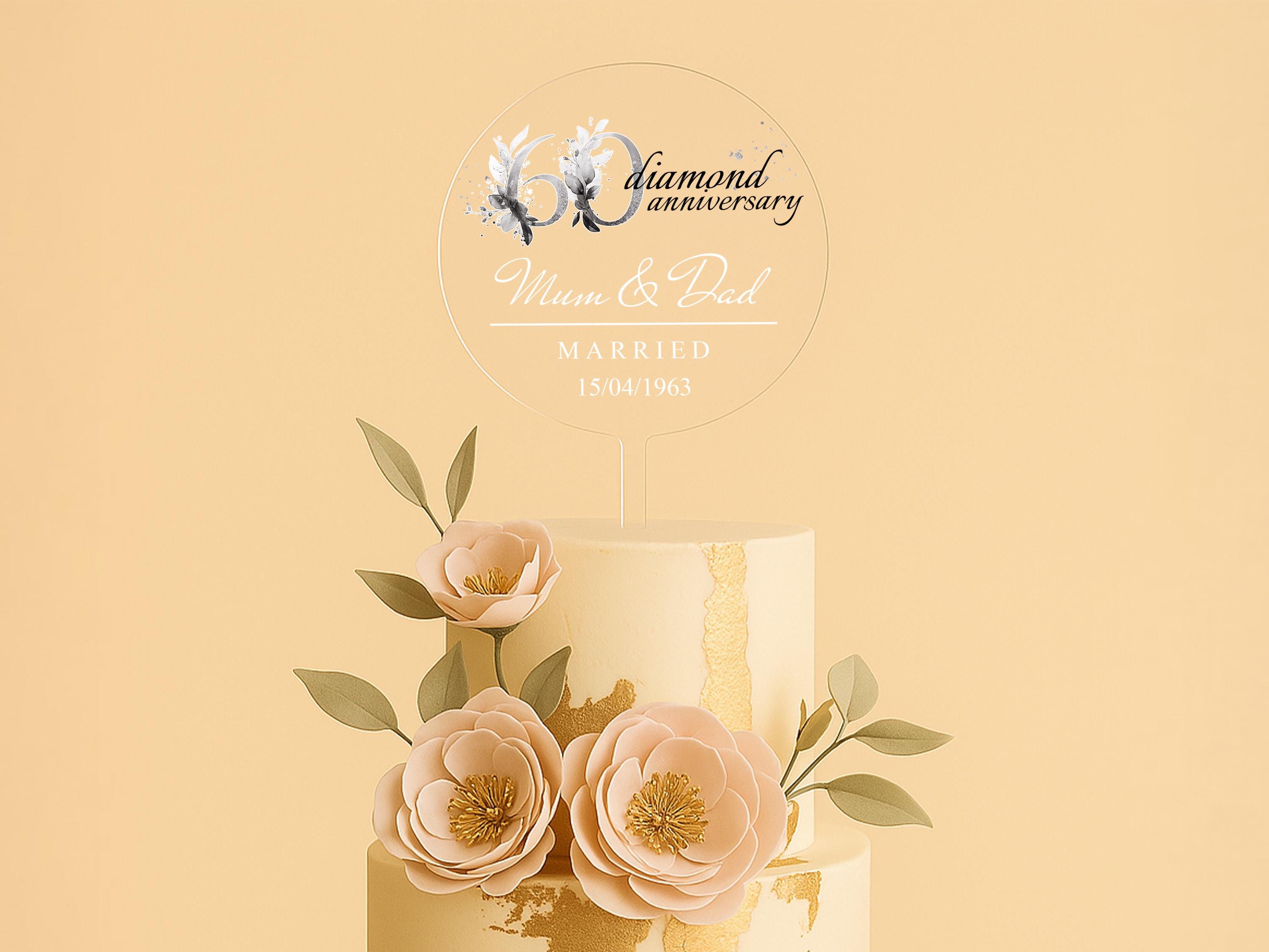 a three tiered wedding cake with flowers on top