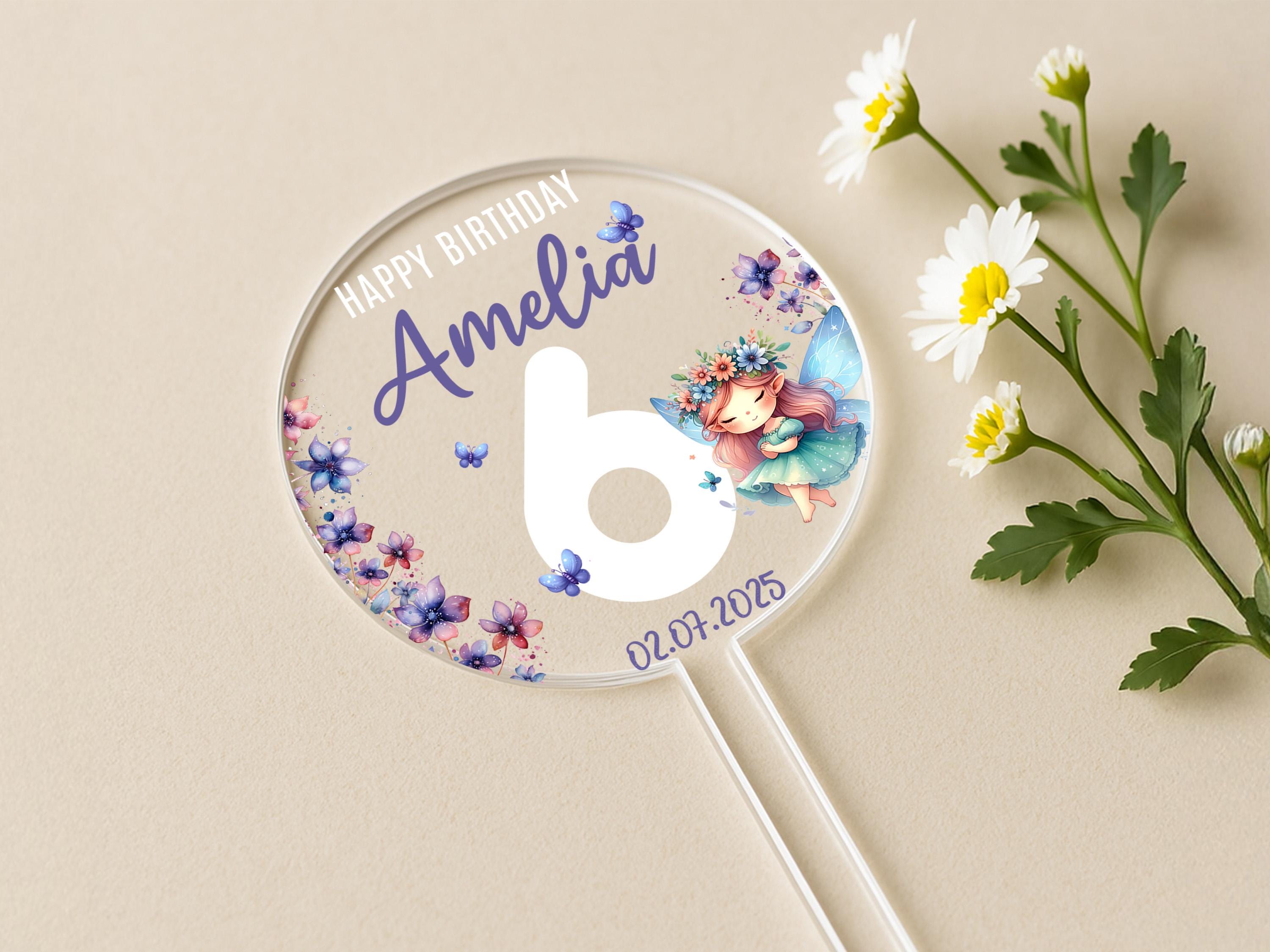 a personalized birthday lollipop next to a flower