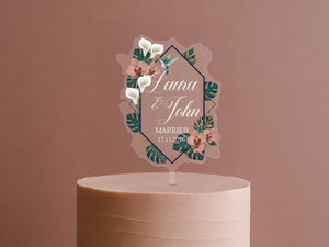 A wedding cake topper with a floral design and text.
