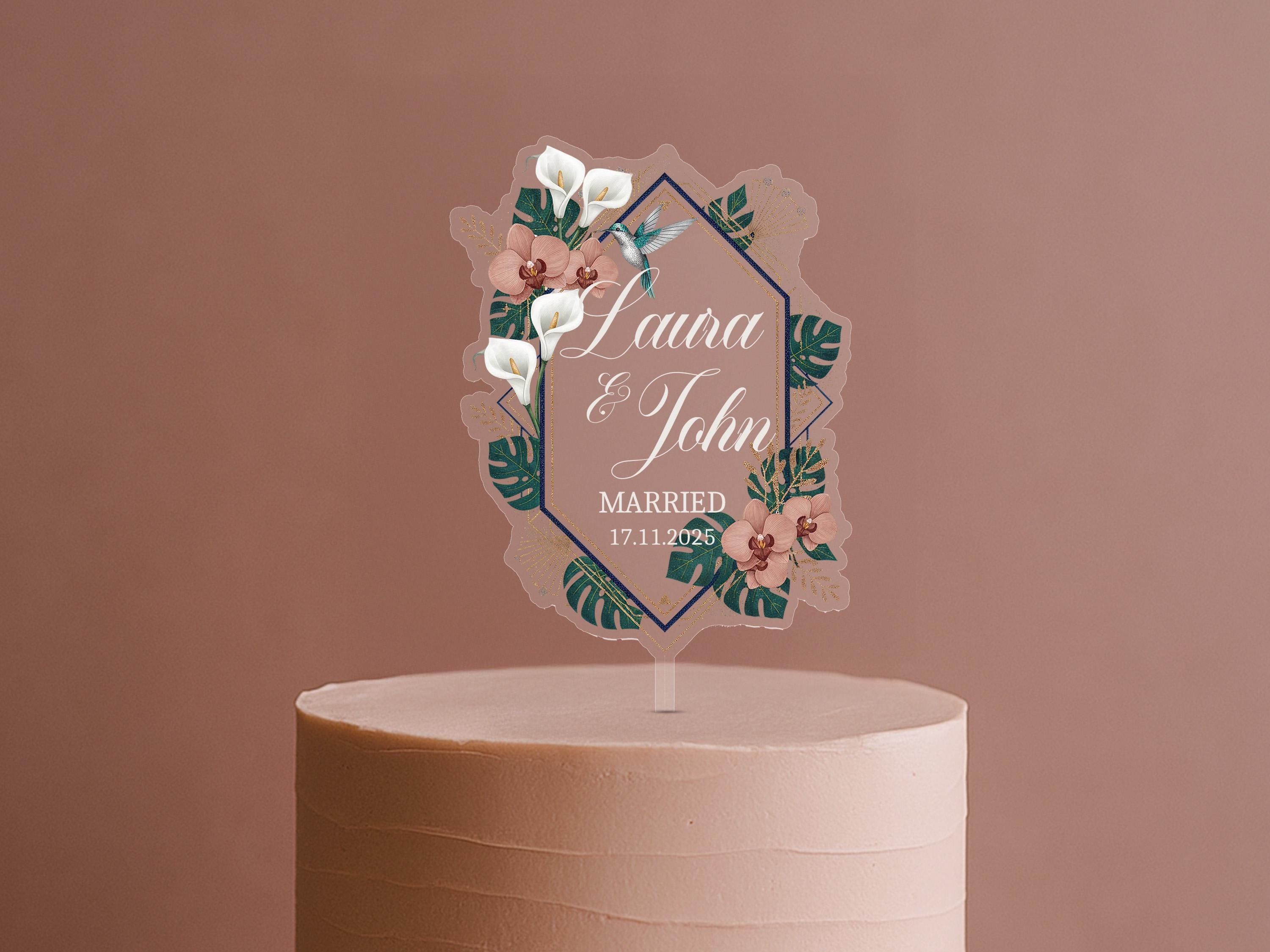 A wedding cake topper with a floral design and text.