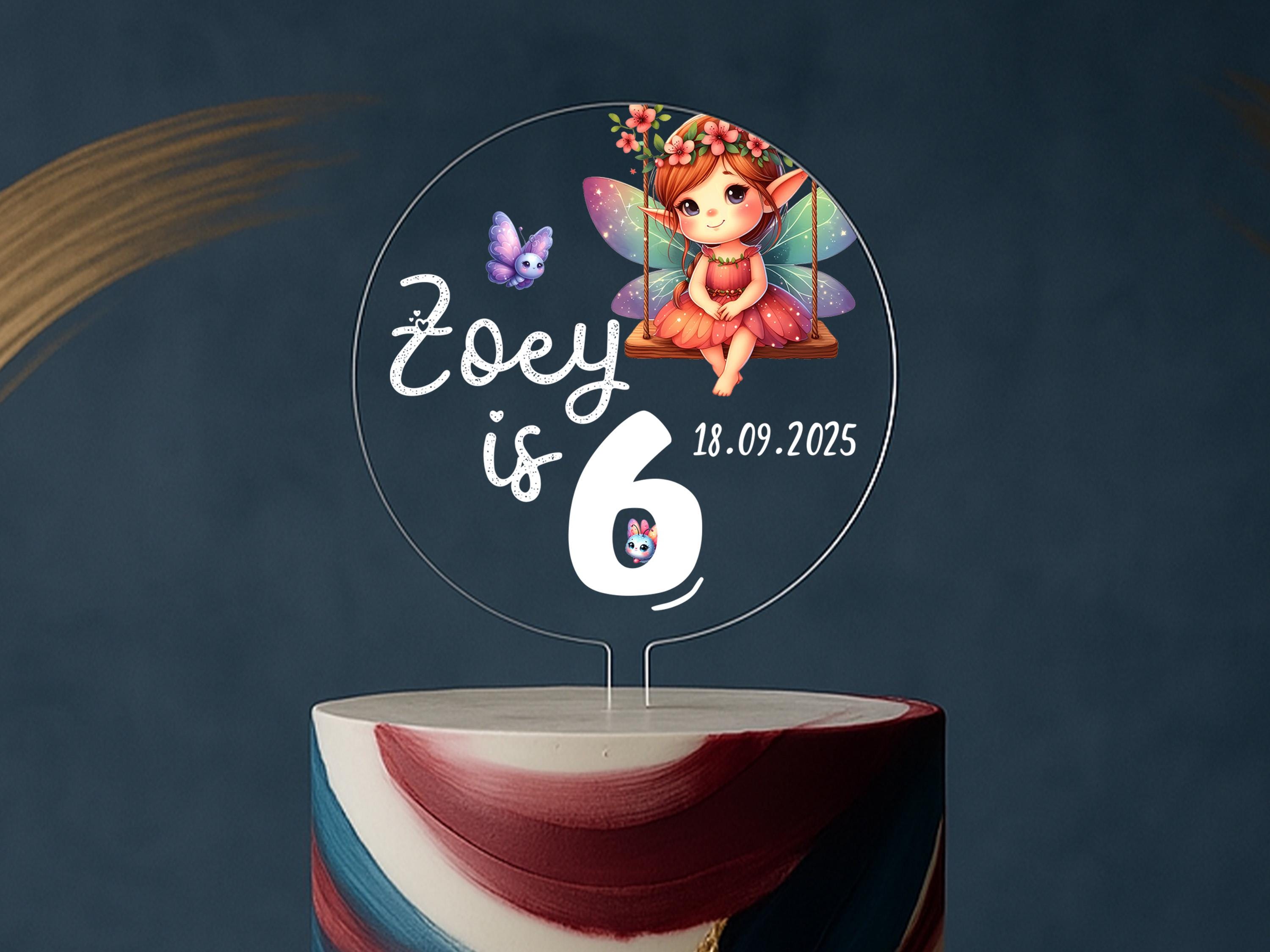 a birthday cake with a picture of a fairy on top