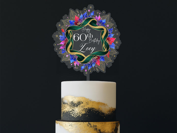 A birthday cake with a decorative topper that says "Happy 60th Birthday Loxy".