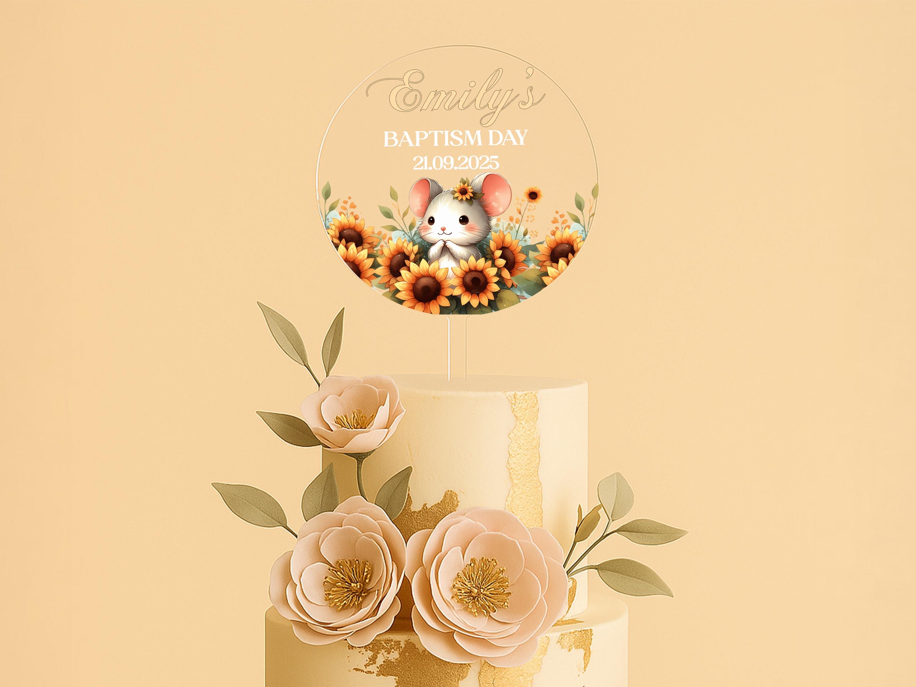 a three layer cake decorated with flowers and a mouse topper