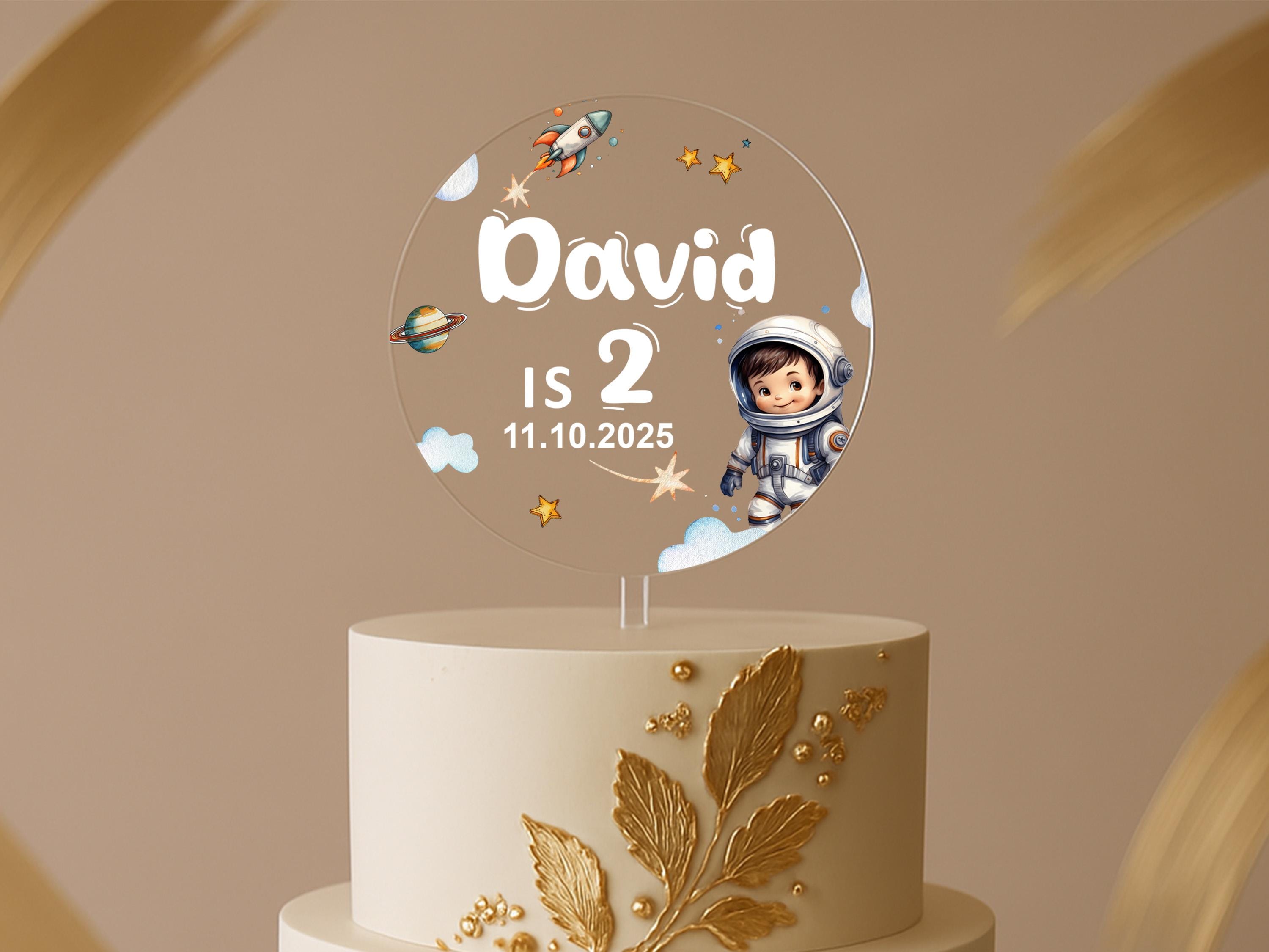 a birthday cake with an astronaut on top of it