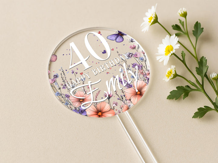 a birthday cake topper with flowers and butterflies