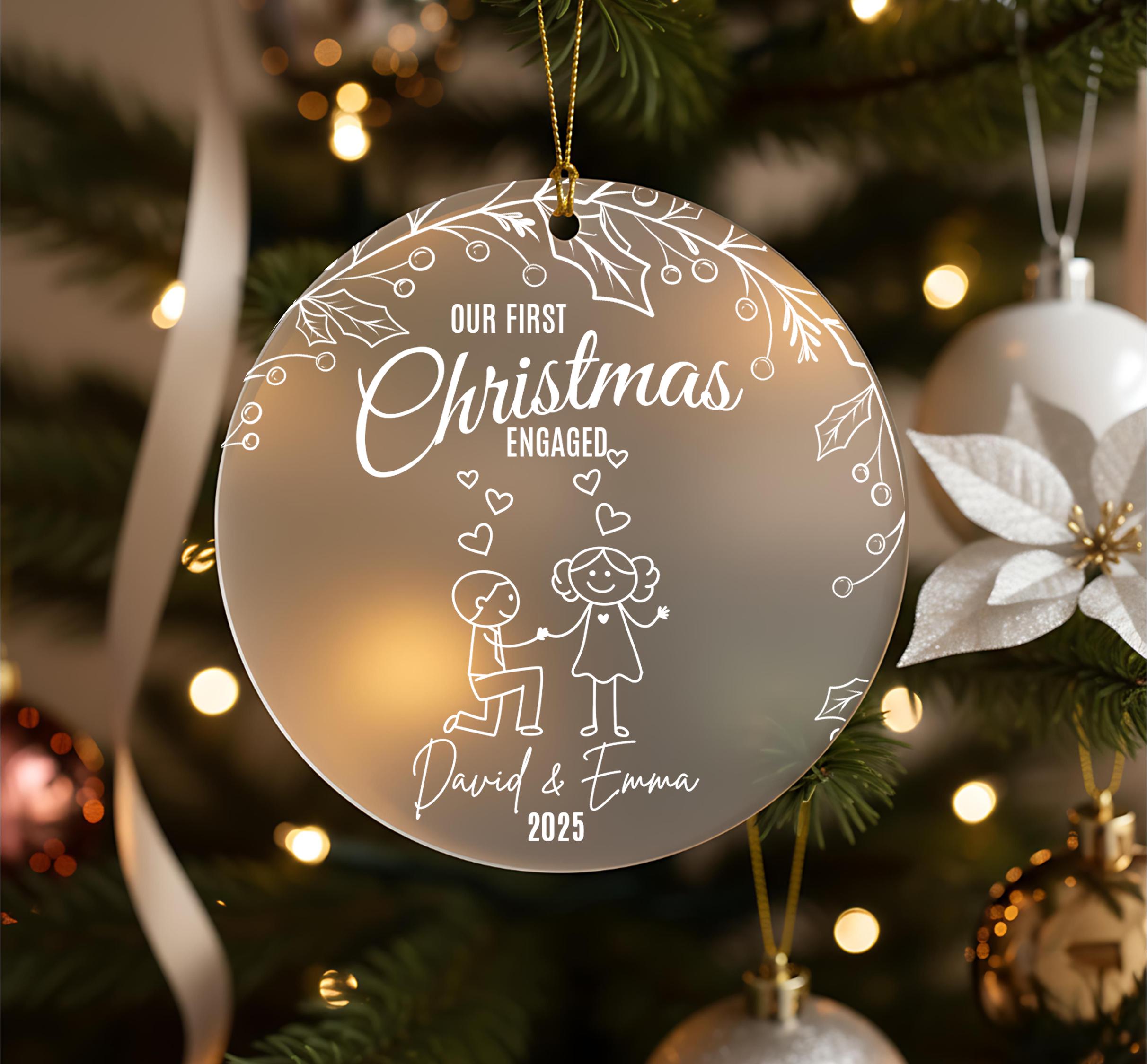 A Christmas ornament with the text "Our first Christmas engaged" and a drawing of a couple embracing.