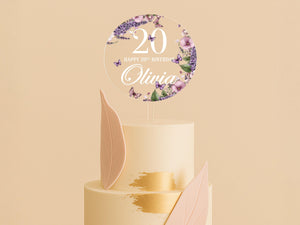 a cake with a white frosting and purple flowers on top