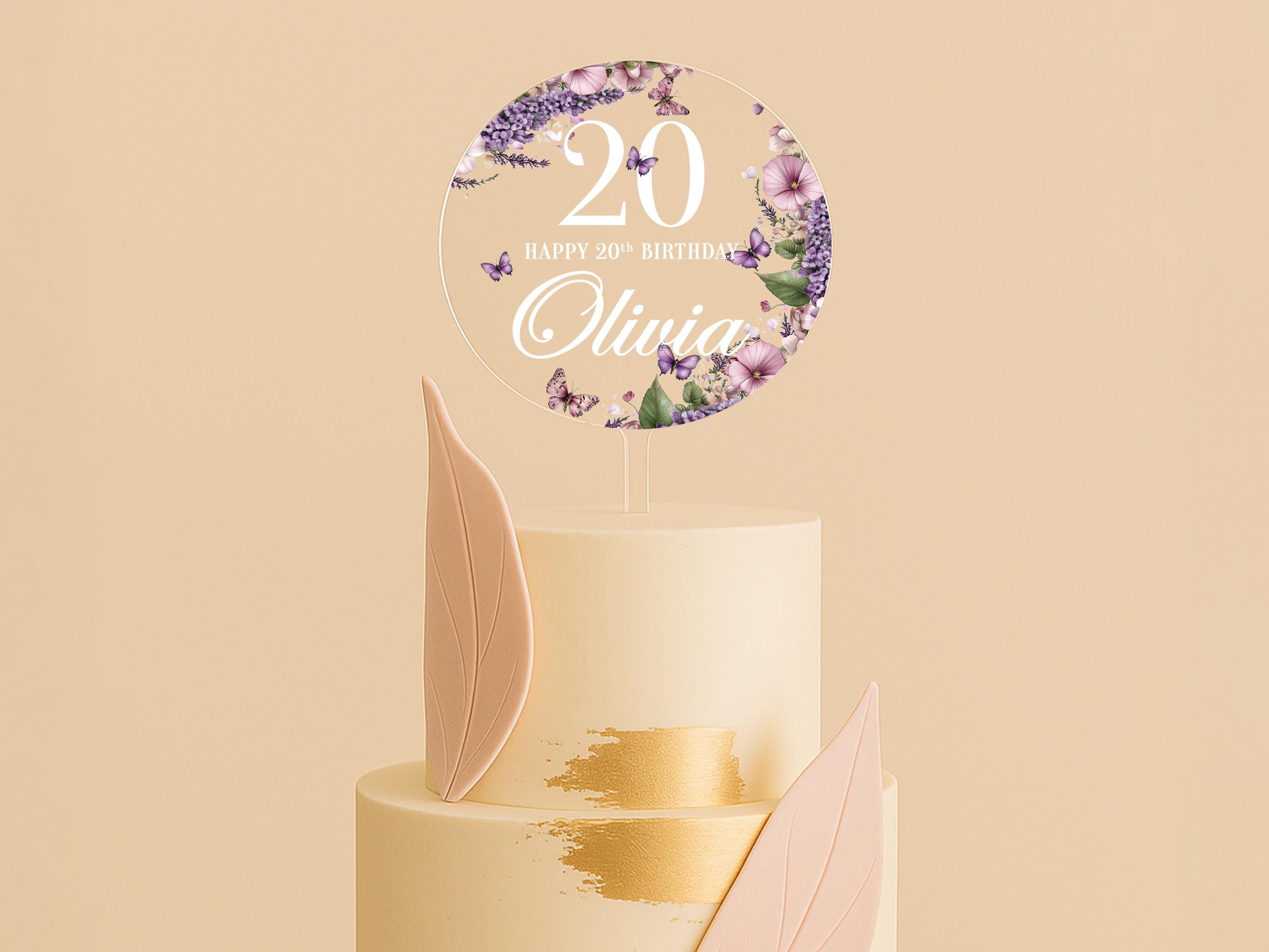 a cake with a white frosting and purple flowers on top