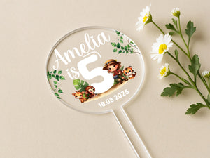 a white and green flower next to a personalized magnifying glass