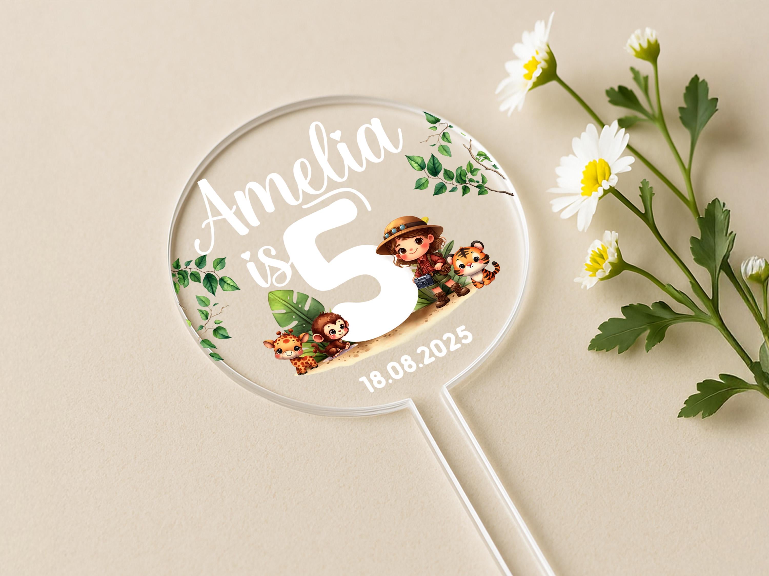 a white and green flower next to a personalized magnifying glass