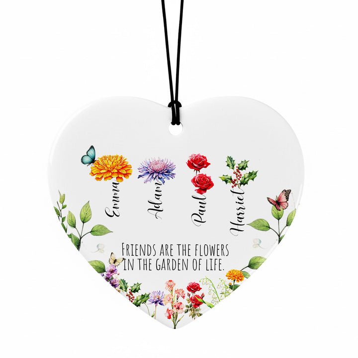 A heart-shaped ornament with a floral design and the text &quot;Friends are the flowers in the garden of life&quot; printed on it.