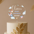 a white and gold cake with a baby's name on top