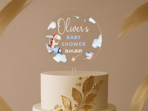 a white and gold cake with a baby's name on top