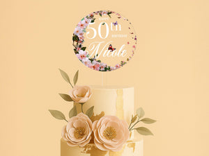 a 50th birthday cake with flowers on top