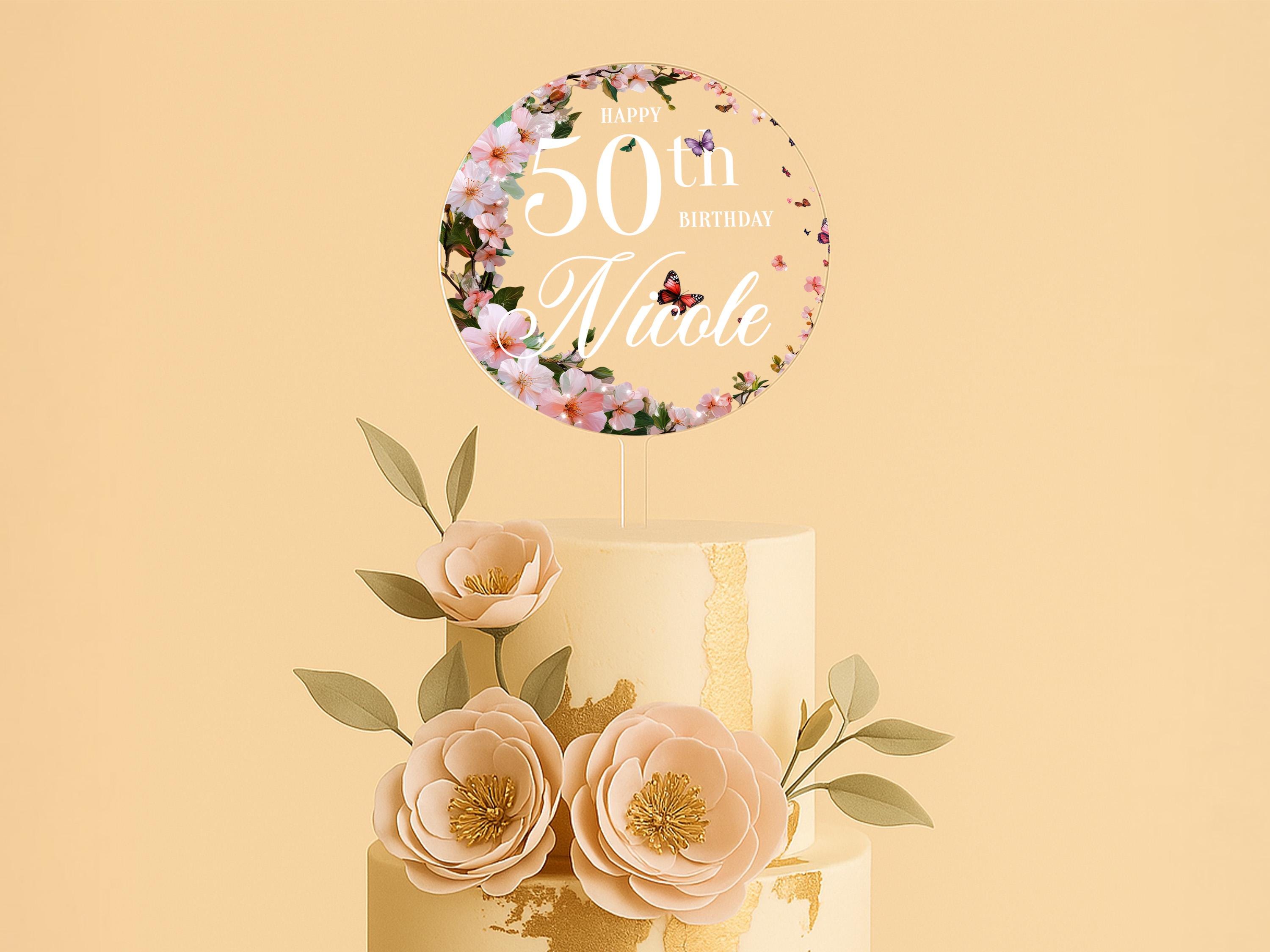 a 50th birthday cake with flowers on top