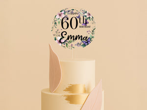 a white cake with a gold leaf decoration on top