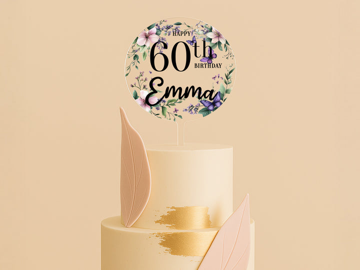 a white cake with a gold leaf decoration on top