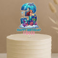 Personalised mermaid birthday cake topper featuring number 3 with red-haired mermaid, dolphin, jellyfish, sea turtle, coral reef and custom name Olivia on white celebration cake