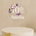 a birthday cake with a white frosting and purple butterflies on it