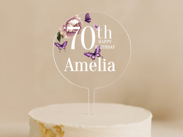a birthday cake with a white frosting and purple butterflies on it