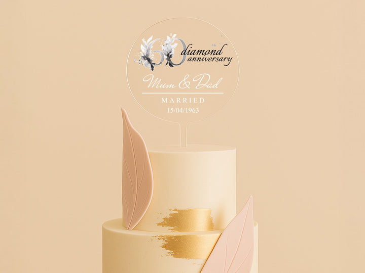 a three tiered wedding cake with a gold leaf decoration