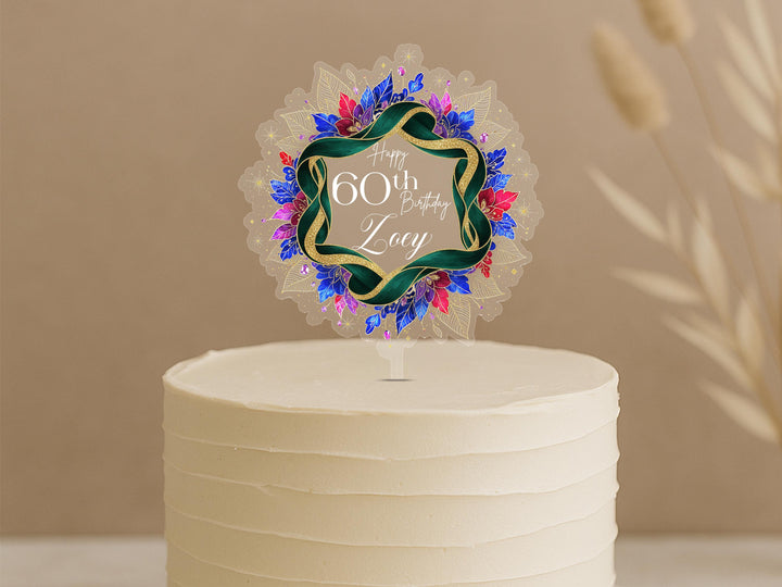 A white cake with a decorative topper that says "Happy 60th Birthday Zoey".