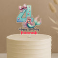 Personalised mermaid birthday cake topper featuring aqua number 4 with pink bow, starfish, bubbles, beautiful mermaid with pink hair and custom name Hannah on white celebration cake