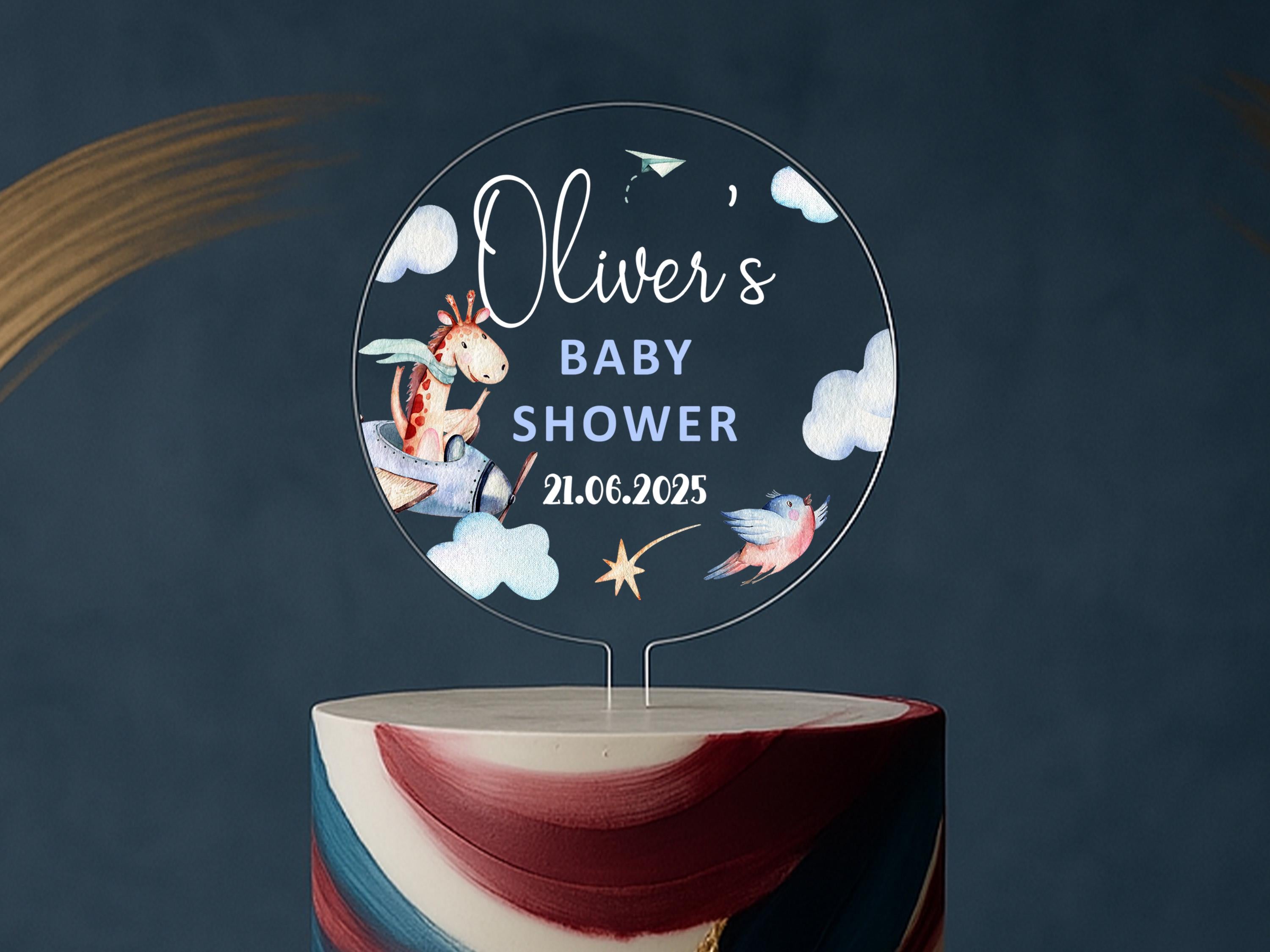 a baby shower cake with a topper on it