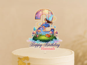 A birthday cake topper with a fairy and a number 2, along with the text "Happy Birthday Hannah".