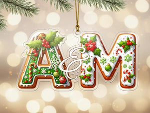 A decorative Christmas ornament with the letters 'A&M' made of gingerbread cookies, decorated with holly leaves, berries, snowflakes, and other festive elements.