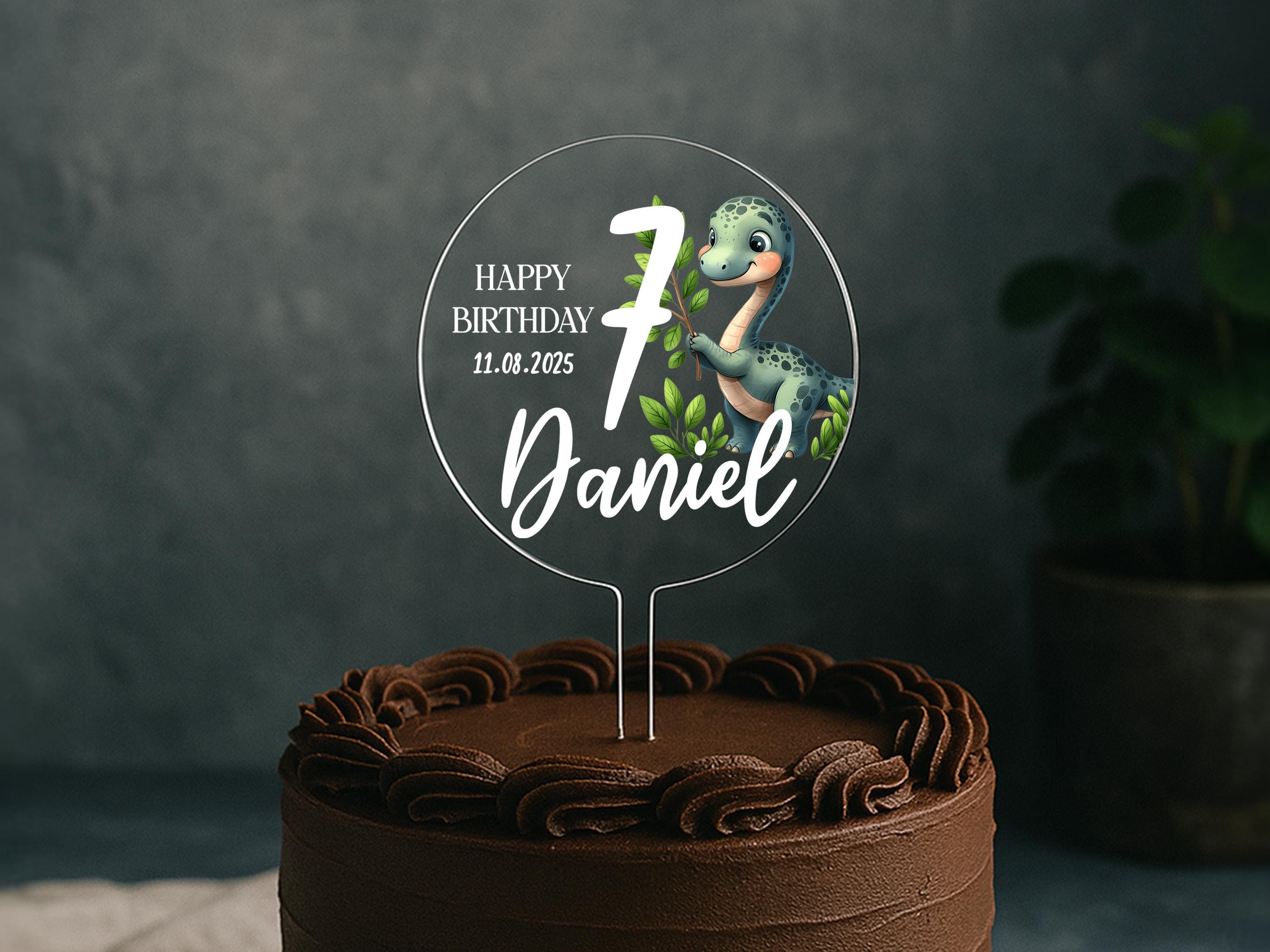 a birthday cake with a dinosaur cake topper