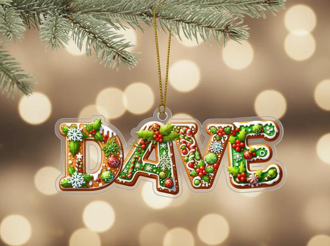 A clear ornament shaped like the name "DAVE" made of gingerbread cookies, decorated with various Christmas-themed elements such as berries, snowflakes, and pine branches.