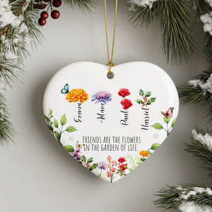 A heart-shaped ornament with a floral design and the names of four friends, each represented by a different flower. The ornament is hanging from a string, and there is a text message below it that reads "Friends are the flowers in the garden of life".