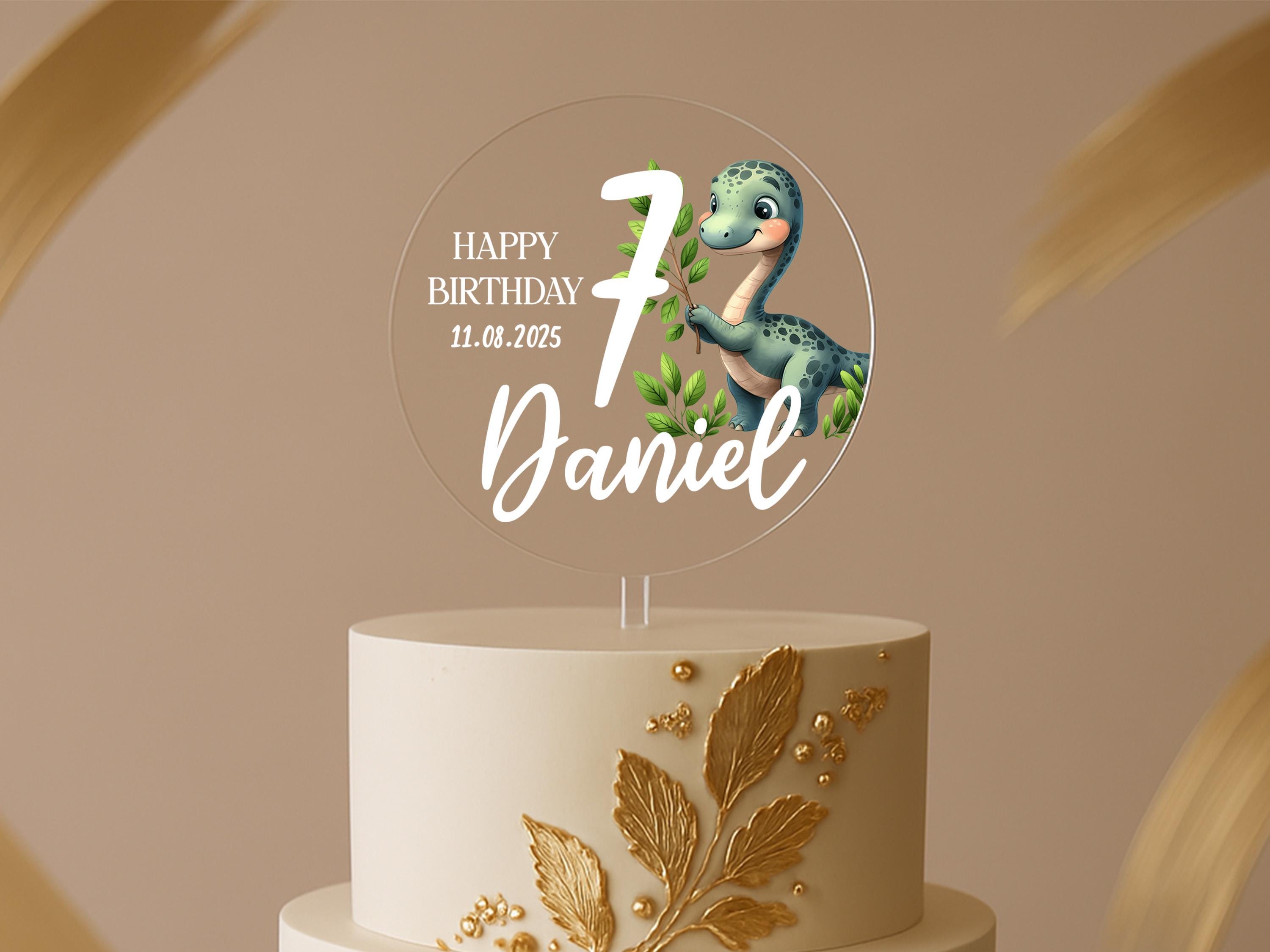 a birthday cake with a dinosaur topper on it