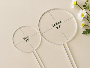 two transparent measuring tools, each marked with measurements in centimeters.