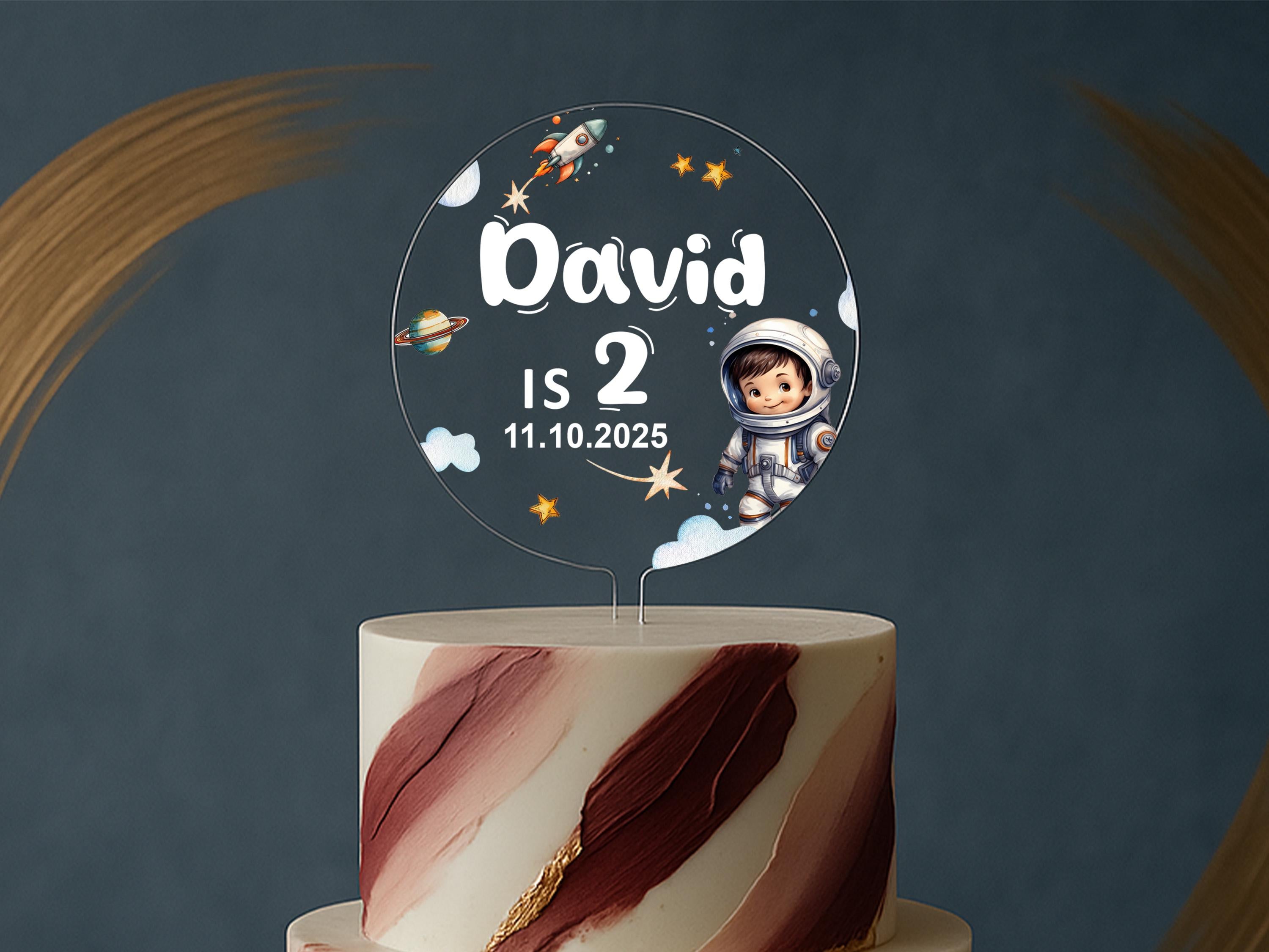 a birthday cake with a space themed topper