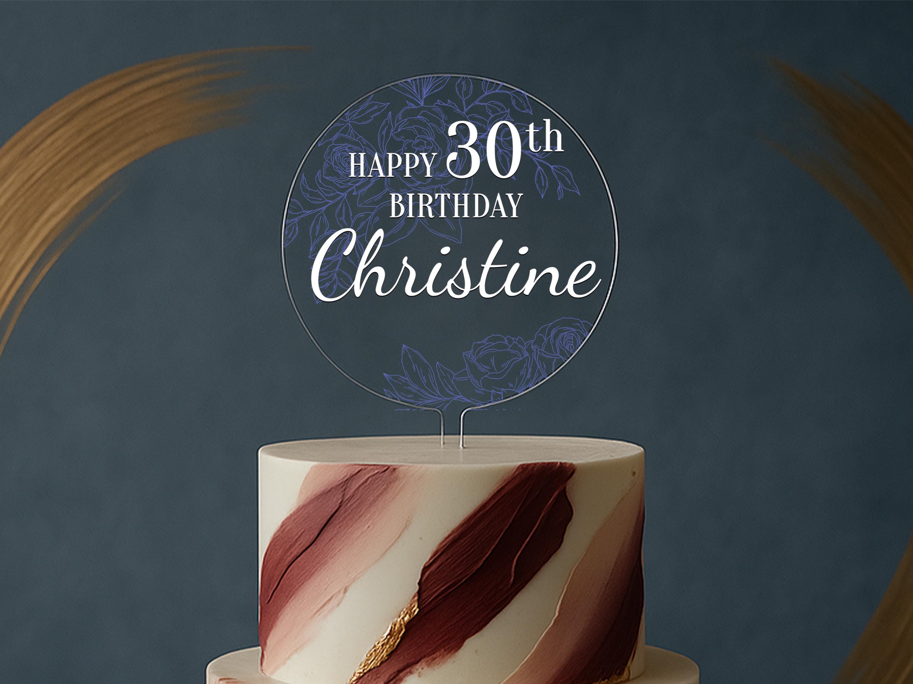 a white and red cake with a sign on top of it