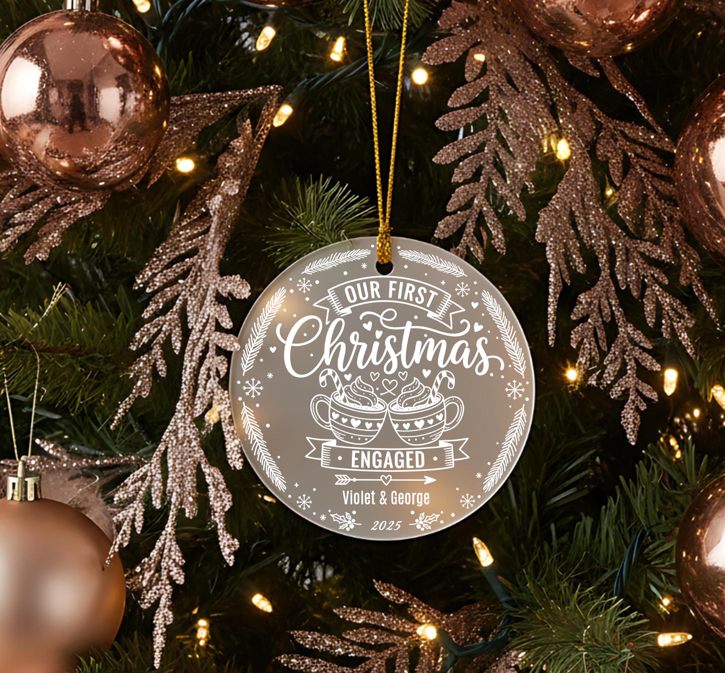 A Christmas tree decorated with ornaments, including a large ornament that says "Our first Christmas" and "Engaged" in white text.