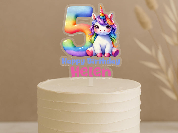Custom unicorn birthday cake topper featuring rainbow number 5 with magical unicorn design and personalised name Helen on buttercream cake