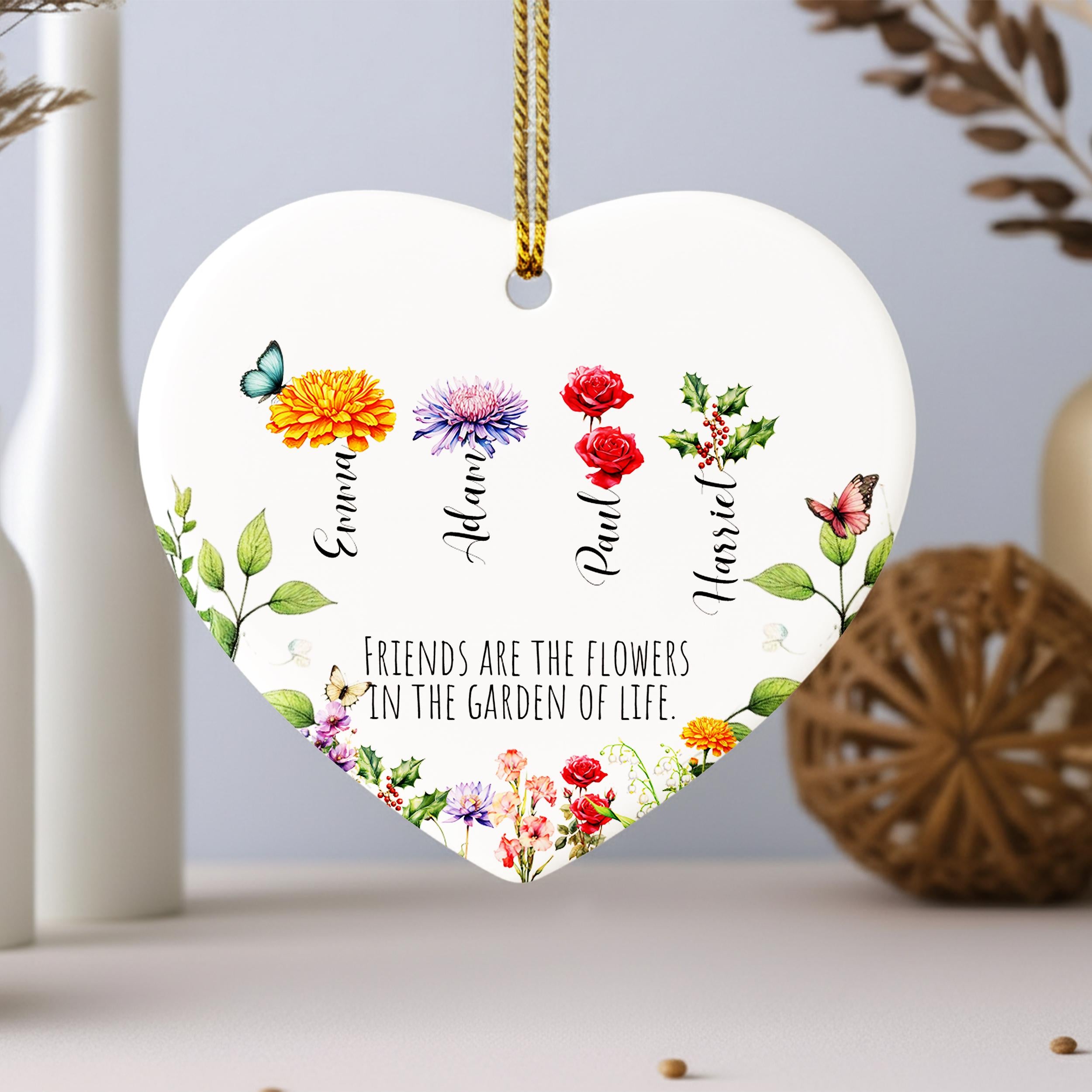 A heart-shaped ornament with a floral design and the text "Friends are the flowers in the garden of life" printed on it.