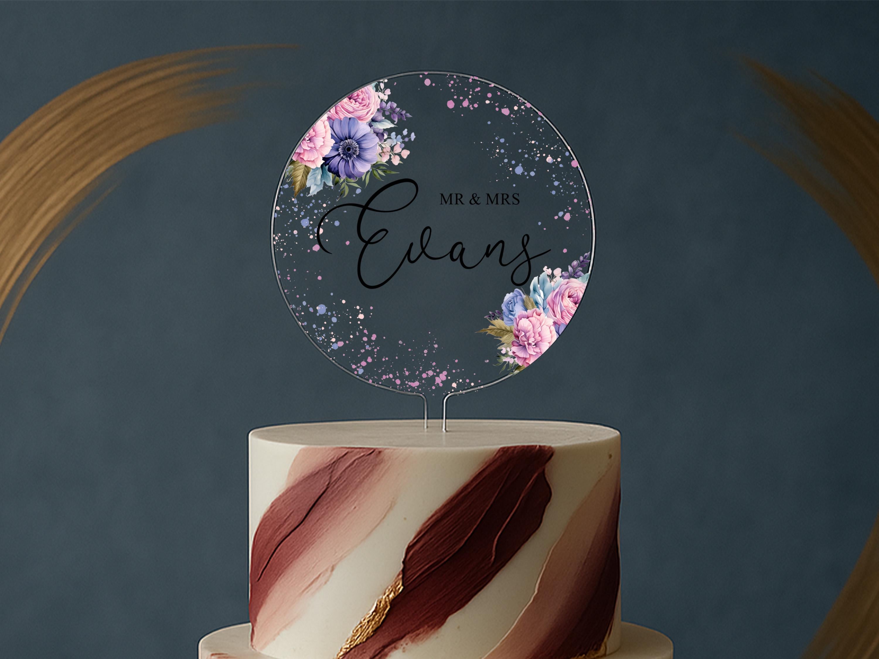 a wedding cake with a cake topper that reads mr and mrs evans