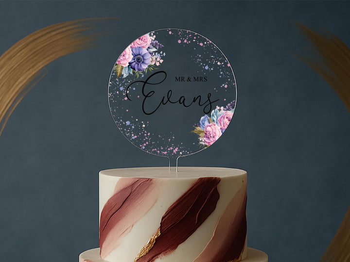 a wedding cake with a cake topper that reads mr and mrs evans
