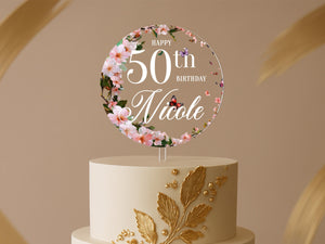a white and gold cake with a 50th birthday cake topper