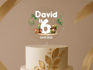 a white cake with a gold leaf decoration on top