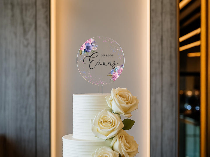 a white wedding cake with flowers on top